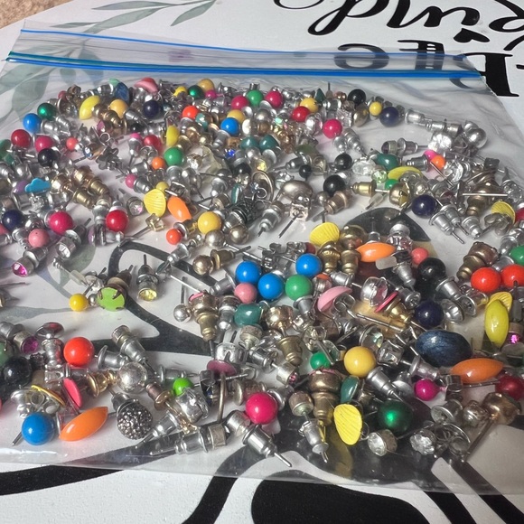 Bag full of different colored stud earrings. - Picture 6 of 13